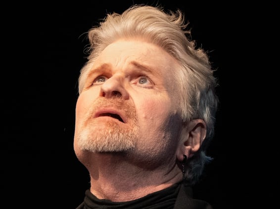 Ward as The Player looking up at the sky.